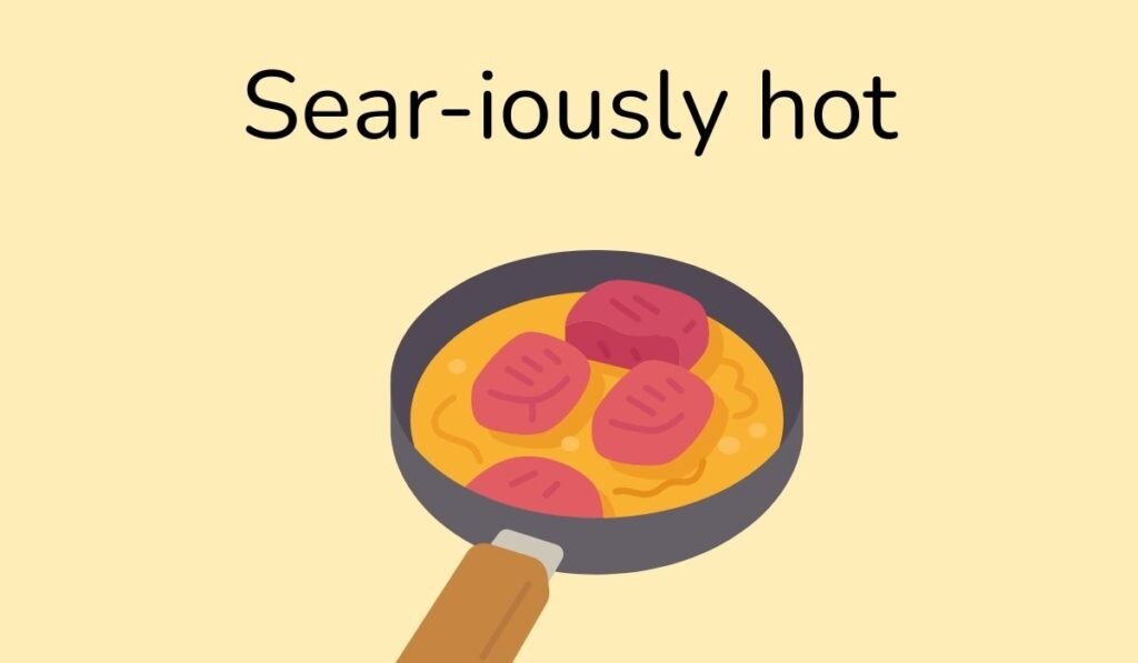 Sear-iously hot – Cartoon frying pan with sizzling meat pieces, playful food pun illustration.